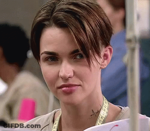 A Woman With A Tattoo On Her Neck Is Holding A Piece Of Paper . GIF