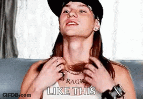 A Woman With A Tattoo On Her Neck Is Sitting On A Couch And Looking Up At The Sky . GIF