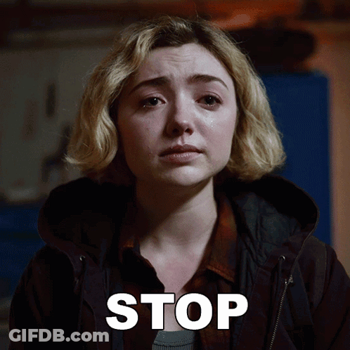A Woman With A Tear Running Down Her Face Is Next To A Stop Sign GIF