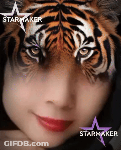 A Woman With A Tiger Face Painted On Her Face And The Word Starmaker On The Bottom GIF