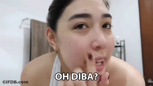 A Woman With A Towel Around Her Neck Is Looking At Her Face And Says Oh Diba ? GIF