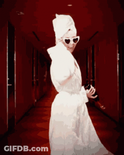 Woman With Towel On Head Holding Wine Bottle GIF