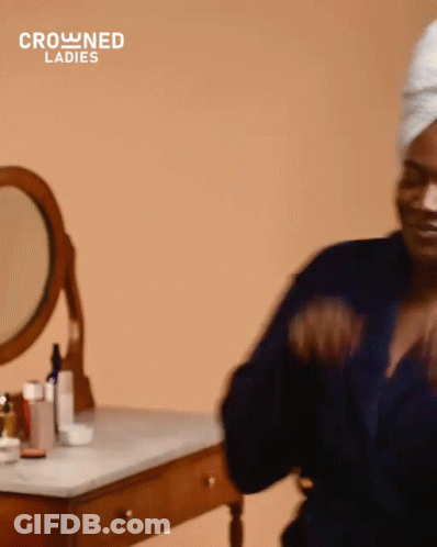 Woman With Towel Wrapped Around Head At Dressing Table GIF