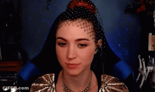 A Woman With A Veil On Her Head And A Necklace GIF