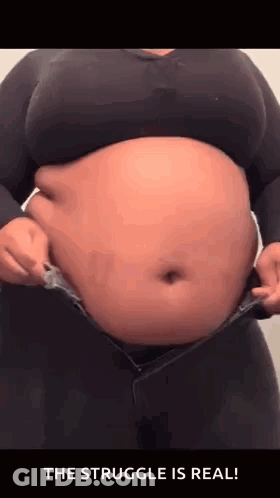 Woman With Large Belly In Black Shirt And Jeans GIF