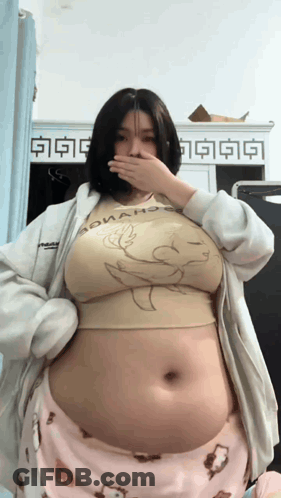 A Woman With A Very Large Belly Is Wearing A Shirt That Says Donald Duck GIF