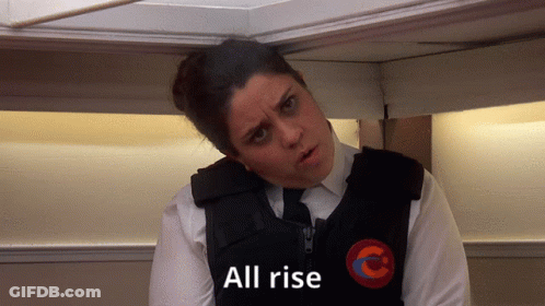A Woman With A Vest That Says All Rise On It GIF