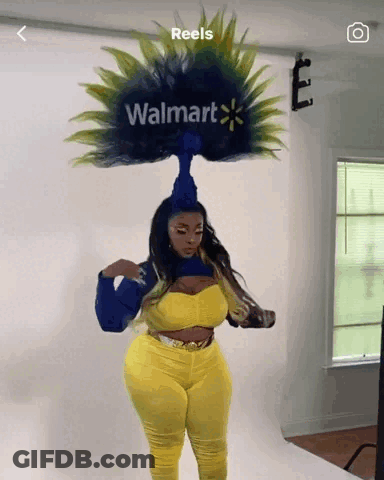 A Woman With A Walmart Logo On Her Head Stands In Front Of A White Wall GIF
