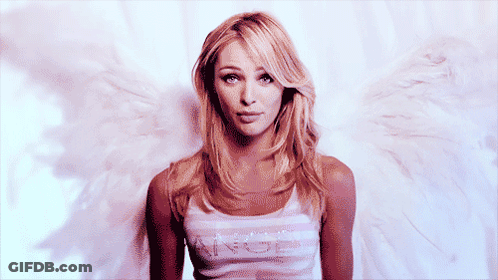 A Woman With Angel Wings Is Wearing A Tank Top With The Word Angel On It GIF