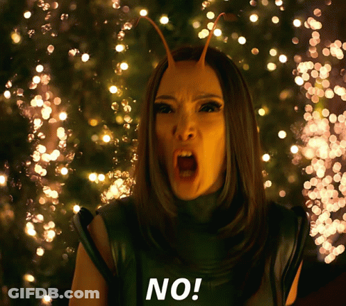 A Woman With Antennas On Her Head Says No In Front Of Christmas Lights GIF