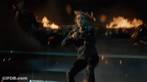 A Woman With Antlers Is Holding A Gun In Her Hand GIF