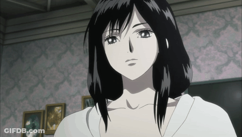 A Woman With Black Hair And A White Shirt Is Standing In Front Of A Pink Wall GIF