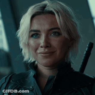 A Woman With Blonde Hair And A Black Jacket Is Smiling GIF