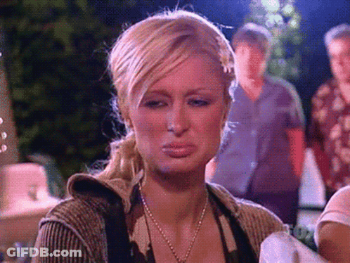 A Woman With Blonde Hair And A Ponytail Is Making A Sad Face GIF
