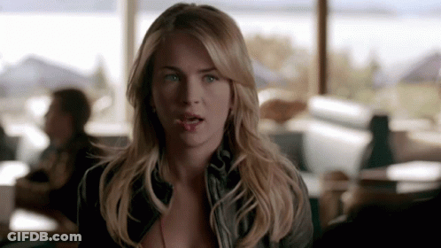 A Woman With Blonde Hair And Blue Eyes Is Looking At The Camera With A Surprised Look On Her Face GIF