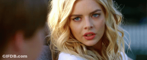 A Woman With Blonde Hair And Blue Eyes Is Looking At The Camera With A Surprised Look On Her Face . GIF