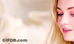 A Woman With Blonde Hair And Blue Eyes Is Smiling GIF