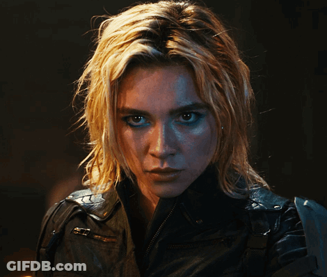 A Woman With Blonde Hair And Blue Eyes Is Wearing A Black Jacket GIF