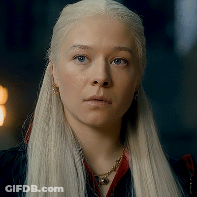 A Woman With Blonde Hair And Blue Eyes Is Wearing A Necklace And Earrings GIF