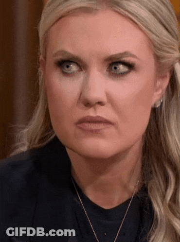 A Woman With Blonde Hair And Blue Eyes Is Wearing A Necklace GIF