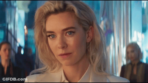 A Woman With Blonde Hair And Blue Eyes Is Wearing A White Shirt And Tie GIF