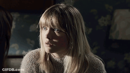 A Woman With Blonde Hair And Blue Eyes Looks Surprised GIF