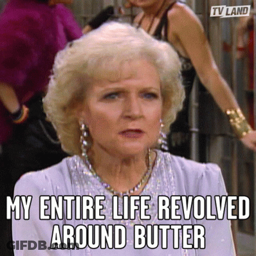 A Woman With Blonde Hair And Earrings Is Sitting In Front Of A Group Of Women . GIF