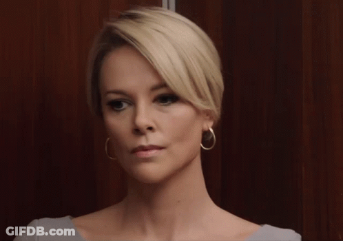 A Woman With Blonde Hair And Gold Hoop Earrings GIF
