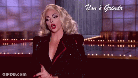 A Woman With Blonde Hair And Red Lips Is On A Stage With The Words Non E Grindr Below Her GIF