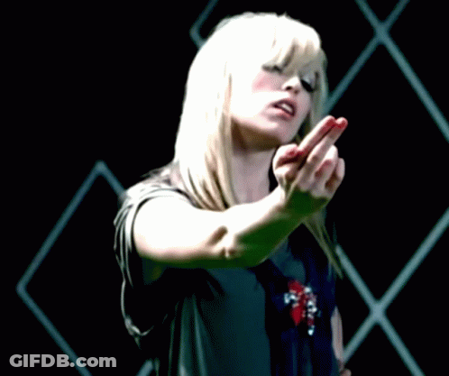 A Woman With Blonde Hair And Red Nails Is Making A Middle Finger Gesture GIF
