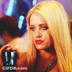 A Woman With Blonde Hair Is Holding A Cup With A Straw In Her Hand GIF