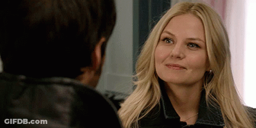 A Woman With Blonde Hair Is Looking At A Man GIF