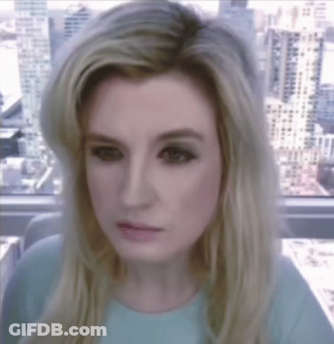 A Woman With Blonde Hair Is Looking At The Camera GIF
