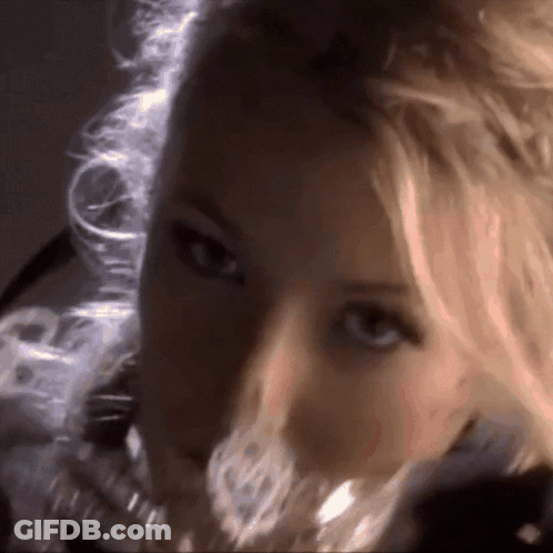 A Woman With Blonde Hair Is Looking At The Camera GIF