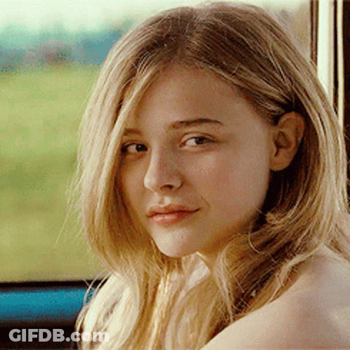 A Woman With Blonde Hair Is Looking At The Camera GIF