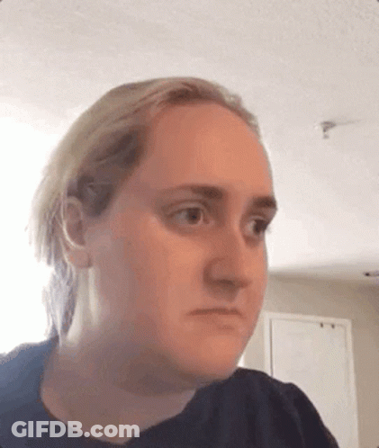 A Woman With Blonde Hair Is Making A Funny Face . GIF
