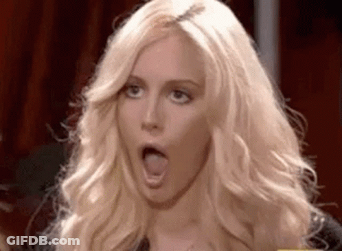 A Woman With Blonde Hair Is Making A Funny Face With Her Mouth Open . GIF