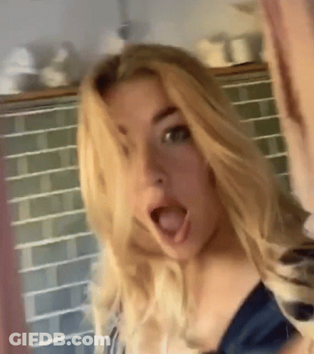 A Woman With Blonde Hair Is Making A Surprised Face With Her Mouth Open GIF