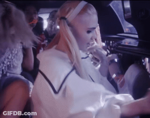 A Woman With Blonde Hair Is Sitting In A Car GIF