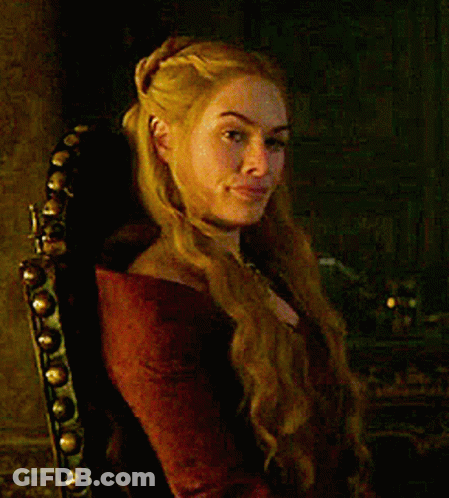 A Woman With Blonde Hair Is Sitting In A Chair GIF
