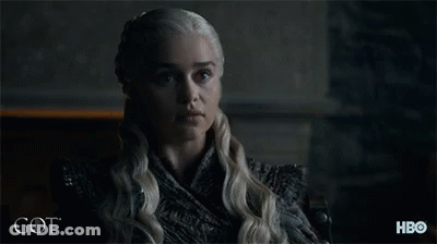 A Woman With Blonde Hair Is Sitting In Front Of A Sign That Says Hbo GIF