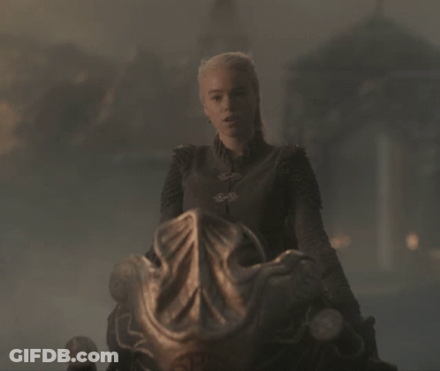 A Woman With Blonde Hair Is Sitting On A Chair GIF