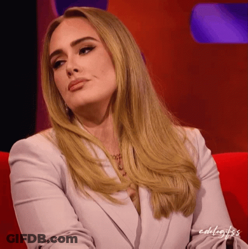 A Woman With Blonde Hair Is Sitting On A Red Couch With The Words Edelagifs Written On The Bottom GIF