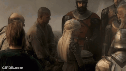 A Woman With Blonde Hair Is Standing In A Crowd Of People GIF