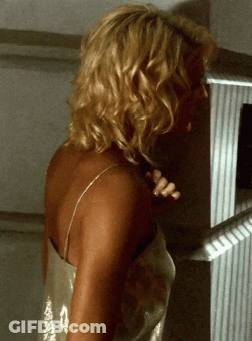 Blonde Woman Standing In Front Of White Wall GIF