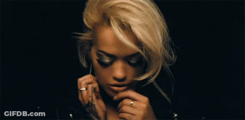 A Woman With Blonde Hair Is Wearing A Black Leather Jacket GIF