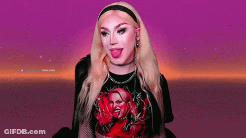 A Woman With Blonde Hair Is Wearing A Black Shirt With A Picture Of A Woman On It GIF