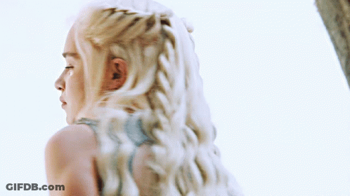 A Woman With Blonde Hair Is Wearing A Blue Top GIF