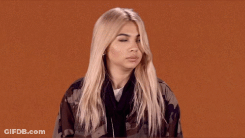 A Woman With Blonde Hair Is Wearing A Camo Jacket And Headphones GIF