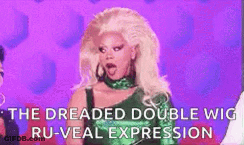 A Woman With Blonde Hair Is Wearing A Green Dress And A Green Wig . GIF